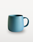 Blue mug on a light gray background