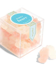 Bubbly bears cube by Sugarfina is fewatured in its square shaped transparente container with blue and gold details label with lettering. In front two of the bubbly bears, on a white background.