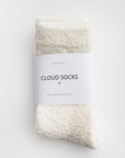 Our signature cloud socks are ivory in color with a white label with black lettering on a white background shown.