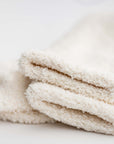 Close up image of our signature cloud socks are ivory in color on a white background shown.