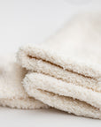 Close up image of our signature cloud socks are ivory in color on a white background shown.