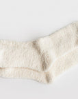 Our signature cloud socks are ivory in color opened on a white background shown.
