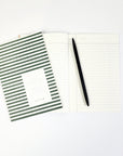 dark green striped pocket notebook opened.