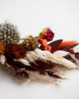 autumn colors dried floral bundle close up image on a white background.