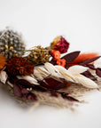 autumn colors dried floral bundle close up image on a white background.