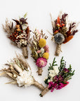 5 dried flower bundles in different colors in a white background.