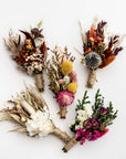 5 dried flower bundles in different colors in a white background.