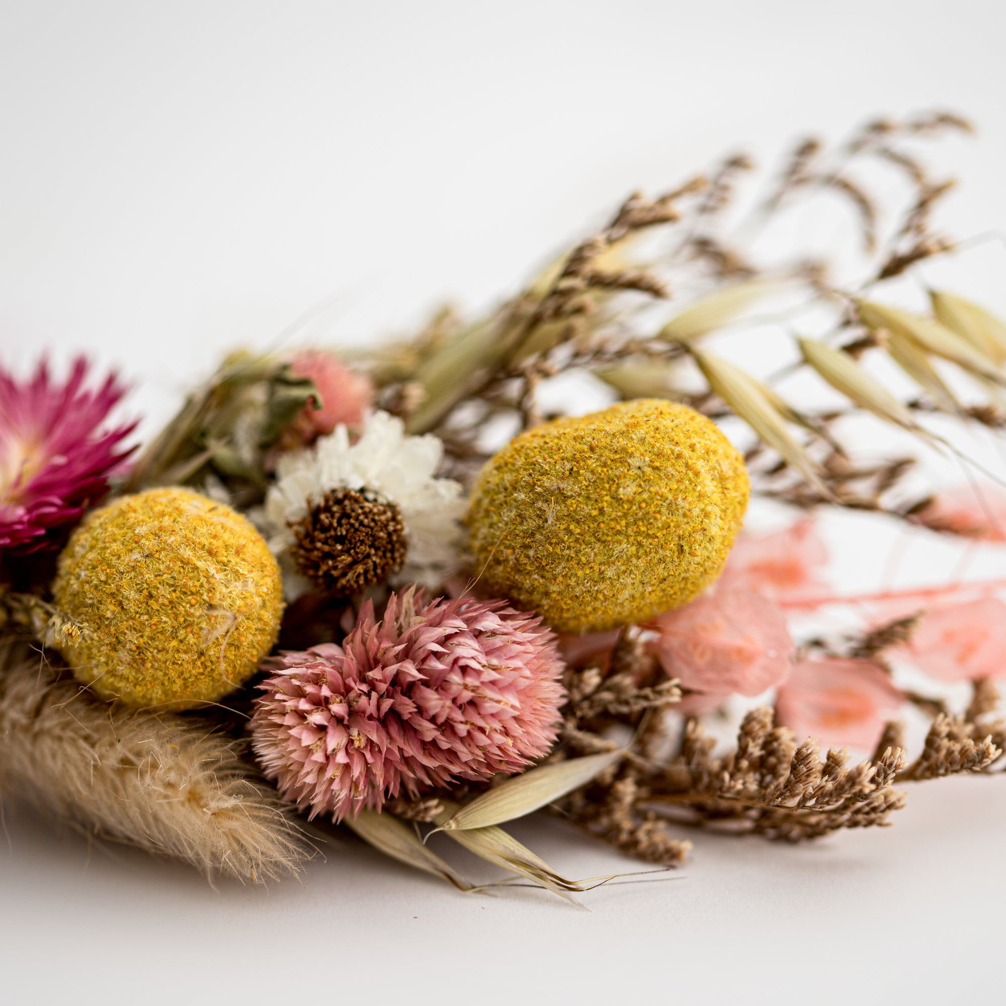 a close up image of a dried flower bundle in a white background.