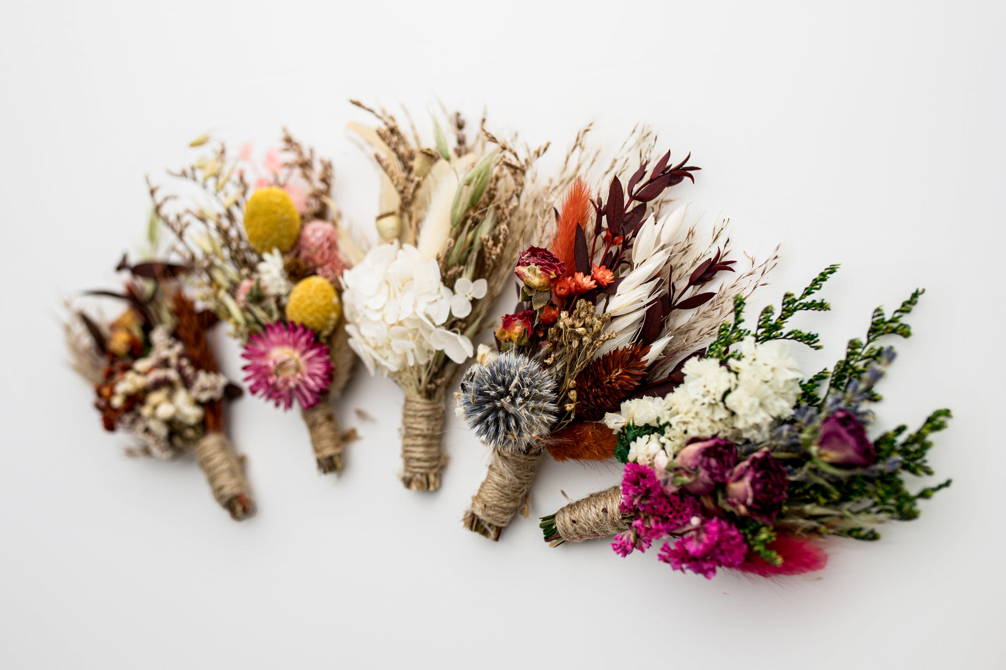 5 dried floral bundles on a white background.