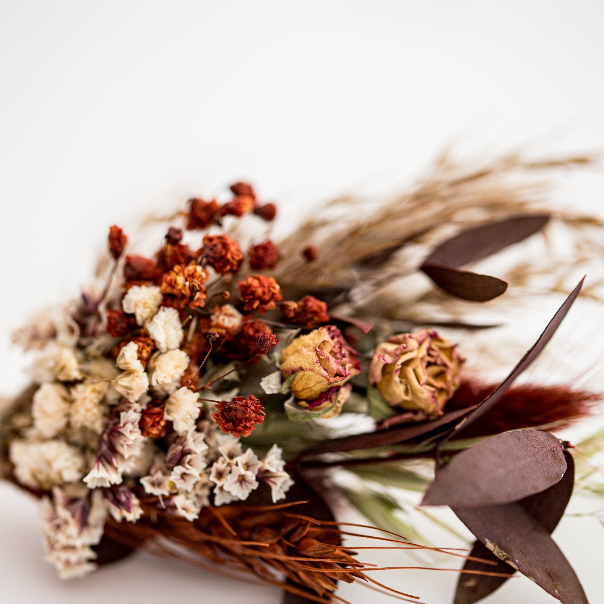 Dried floral bundle close-up image in a white background.
