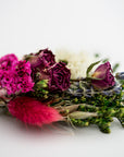 close up image of dried floral bundle on white background.