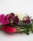 close up image of dried floral bundle on white background.