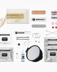 A bridal emergency makeup kit laid out on a white background, including a mini mirror, bandages, bobby pins, cotton swabs, double-sided tape, stain remover, deodorant, and a small bottle of liquid.