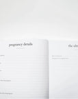 Open book with pregnancy details and ultrasound text on a white background