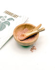 Formulary 55 organic facial mask shown both in its packaging and mixed in a bamboo bowl, accompanied by a bamboo spatula and spoon, displayed on a white background.