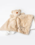 Light brown plush blanket with teddy bear shape and 'Wyatt' embroidery on a white background