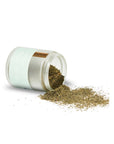 Glass jar with dried herbs spilling out on a white background