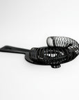Gunmetal cocktail strainer side image on a white background.