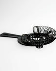 Gunmetal cocktail strainer side image on a white background.