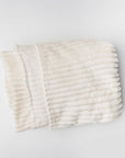 Ivory plush blanket is featured on a white background.