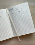 Opened image of green linen recipe book.