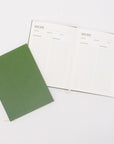 Green recipe book opened and closed