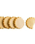Meyer lemon shortbread cookies are featured, five of them in the image, round, sun-shaped cookies on a white background.