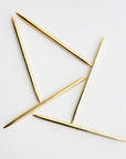 Five minimalist gold pens are featured on a white background.