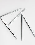 Five minimalist silver pens that have a round shape are featured on a white background.