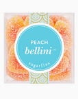 Sugarfina Peach Bellini Gummies in a clear plastic cube-shaped package, showing peach-colored gummy candies inside, each shaped like miniature bottles, with the Sugarfina logo and 'Peach Bellini' label on the front on a white background.