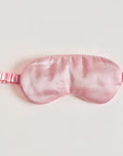 Pink satin sleep mask is featured on a white background.