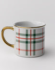Our signature plaid mug gold rim and handle featured being held with chocolate and marshmallows inside on a white background.