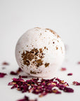 Rose Petal Bath Bomb, featured surrounded by rose petals on a white background.