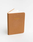 Rust pocket softcover notebook featured on a white background. With Notes printed in front of it.