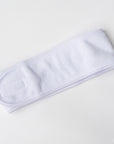Image of white spa headband in a white background.