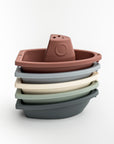 set of five stacking bath boats in various colors on a white background.