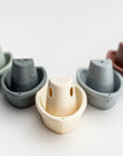 set of five stacking bath boats in various colors on a white background.