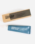 Tender blue hand cream in a brown box. Inside, it has a blue tube with white letters.