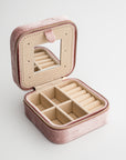 Velvet jewelry box in blush color. Inside light brown divisions includes a mirror.