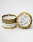 White tea travel size candle in our signature gold tin with white label on lid and tin with a floral design and black lettering.