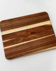 Wooden cutting or serving board brown wooden colored is featured on a white background.