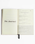 The five minute journal book opened in one page the journal in black letters and on the other side shows how the journal is organized and looks.