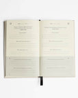 The five minute journal book opened showing the journal distribution and how it looks like. Quote and 5 questions to answer.