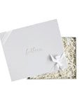 Gray 'Foxblossom Co.' box, white silk ribbon on lid, ivory paper shred in a gray box