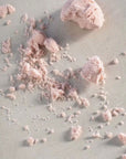 Baby pink tinted truffle, crumble texture.
