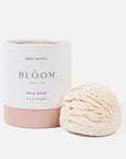 White and pink colored cylinder container, black text, inside bath truffle a cream frozen yogurt like texture.