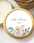 Our Custom wedding favor candle Emily, featured in tis gold tin. The names “emily and jason” are written in a flowing, handwritten-style script, The date "6.23.18" is in clean font. The floral design consists of a blend of soft, pastel colors, including pink, cream, blue, and green tones, executed in a loose watercolor style