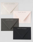 Floral heart card envelope color option chart featuring ivory shimmer, luxe blush, slate gray and matte black.