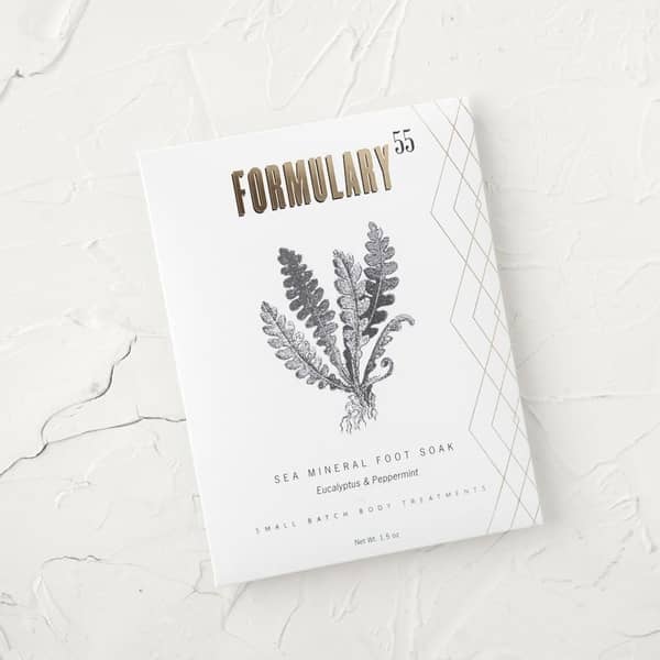 Formulary 55 Sea Mineral Foot Soak in a white packet, with black and gold text, and a black plant graphic.