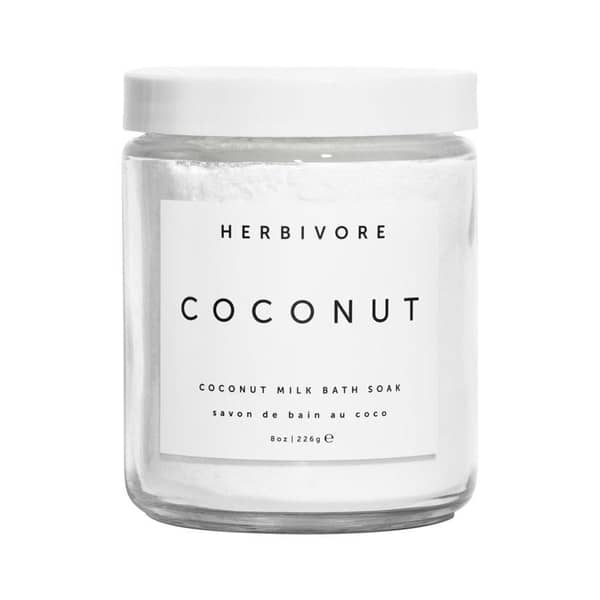 herbivore coconut milk bath soak white powder in clear glass jar with white label and lid